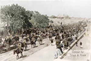 Commandant Lotter's captured commando being marched into Graaff-Reinet with their captors.
